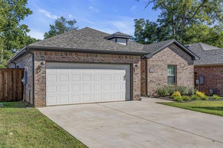 View of front of house with a garage and a front lawn