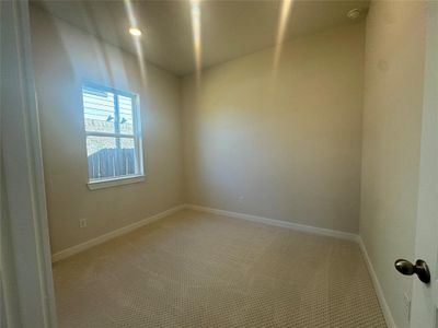 Sizable secondary bedroom with soft and stylish carpet.