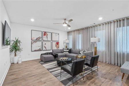 Living room featuring ceiling fan and hardwood / wood-style flooring