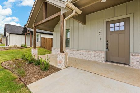 Doorway to property with a lawn and a patio