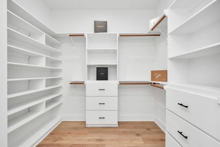 Chic storage haven, tailored organization, fashion-forward luxury in spacious walk-in closet.