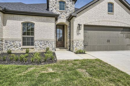 View of front of home with a garage and a front lawn