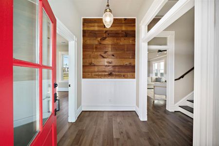 Step in through our signature red front door, into a welcome entry foyer. Reclaimed shiplap and wainscoting feature in here!