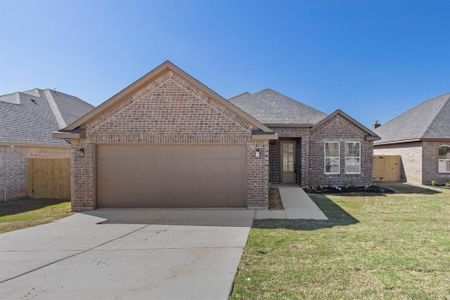 View of front facade featuring a front lawn and a garage