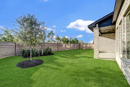 Backyard view with brick wall fencing on back and side yard.