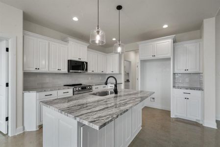 Kitchen with white cabinetry and stainless steel appliances