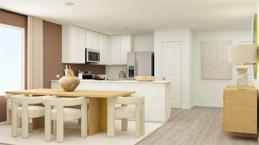 Kitchen with light wood-type flooring, a kitchen bar, stainless steel appliances, and white cabinets