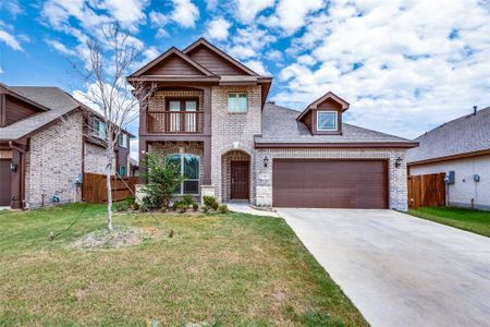 View of front of home with a front yard, a garage, and a balcony