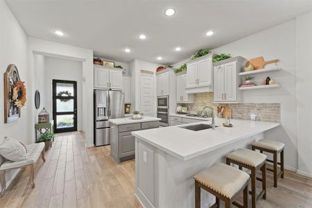 The open concept kitchen has a breakfast bar seating, tons of storage and perfect for hosting.