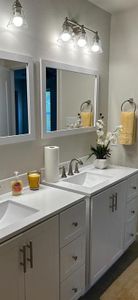 Bathroom with dual vanity and hardwood / wood-style floors