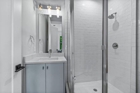 Bathroom with vanity and a shower