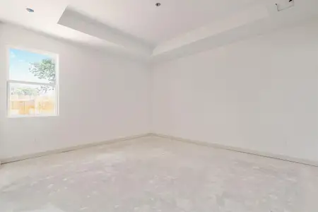 Empty room featuring a tray ceiling