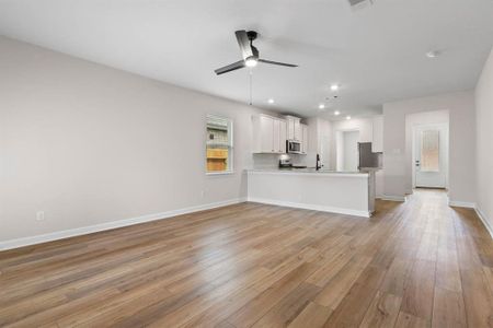 The living room overlooks the kitchen and is spacious enough for a large sectional couch.