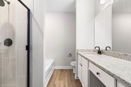 Step into the luxurious en-suite bathroom, where a sleek vanity offers both style and functionality, while a separate tub and shower combo provide the ultimate in relaxation and convenience.