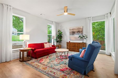 Living room featuring light hardwood / wood-style flooring and ceiling fan