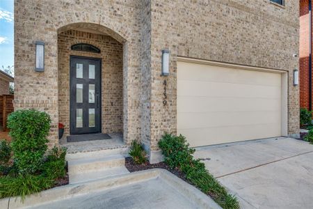 View of exterior entry with a garage