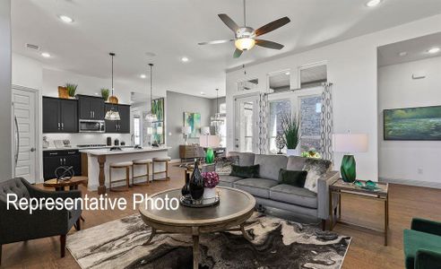 Living room featuring ceiling fan and dark hardwood / wood-style floors