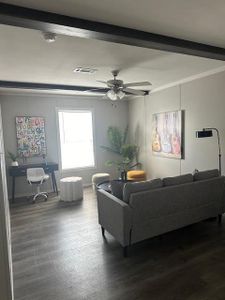 Living room with beamed ceiling, wood-type flooring, and ceiling fan