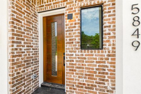 The custom wood entry door hints at the home's many exceptional features.