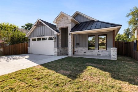 View of front of home featuring a garage and a front lawn