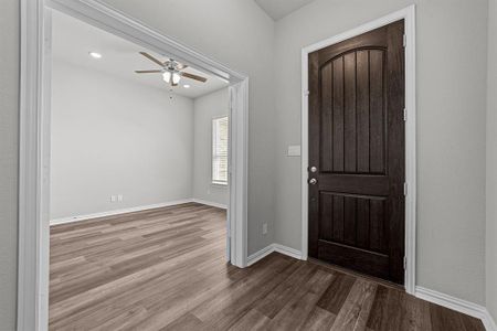 Foyer featuring ceiling fan and wood-type flooring