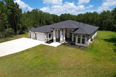 This modern single-story home is located on almost 2 acres of pristine land surrounded by mature trees and each side of the home is outfitted with 2 ethernet/data connections for power over ethernet (POE) for security cameras.