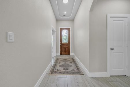 Entryway with light tile patterned flooring