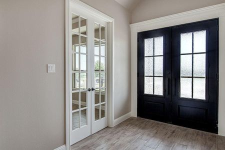 Doorway to outside with wood-type flooring and french doors