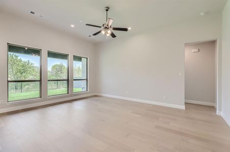 Unfurnished room featuring ceiling fan and light wood-type flooring