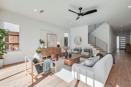 Living room featuring ceiling fan and light hardwood / wood-style floors