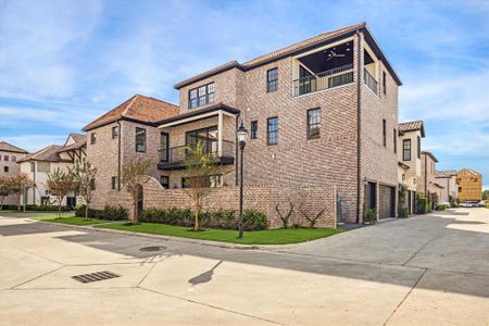 Corner view of this three story home with three car garage