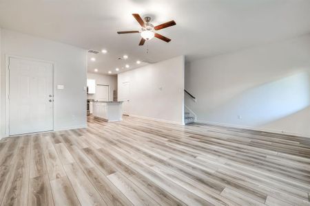 Unfurnished living room featuring light hardwood / wood-style flooring and ceiling fan