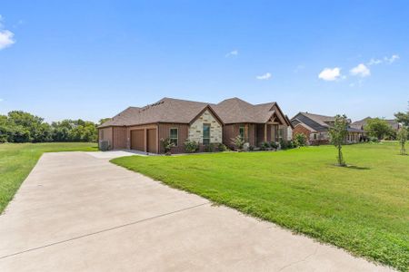 View of front of property with a garage and a front yard