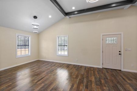 Foyer featuring a wealth of natural light, high vaulted ceiling, beam ceiling, and hardwood / wood-style floors