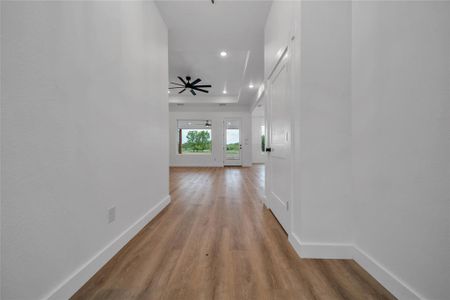 Corridor with light hardwood / wood-style flooring