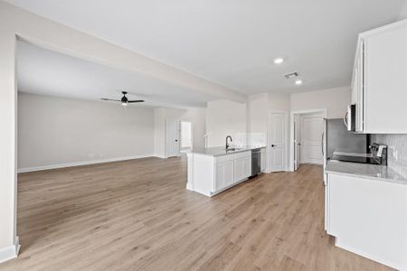 Kitchen with LVP flooring, 42" Cabinets, and a glimpse of the living area.