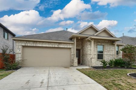 View of front of house with a front lawn and a garage