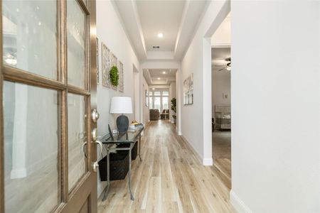 Welcome guests into your beautiful new home through the glass-paned wood door.