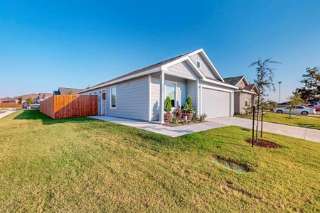 Single story home featuring a garage and a front lawn