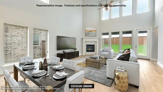 Living room with a towering ceiling, plenty of natural light, and light wood-type flooring