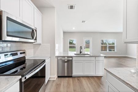 Kitchen with new Whirlpool appliances.