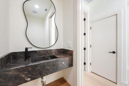 Bathroom featuring hardwood / wood-style flooring and sink