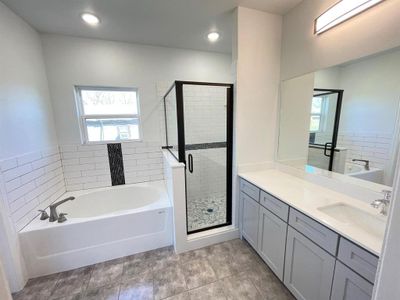 Bathroom with vanity, plus walk in shower, and tile patterned flooring