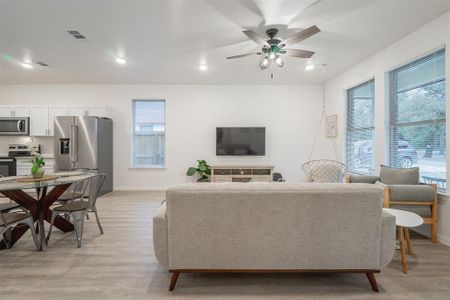 Living room featuring light wood-type flooring and ceiling fan