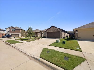 View of front of property with a front yard and a garage