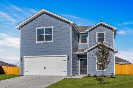 View of front of house with a front lawn and a garage