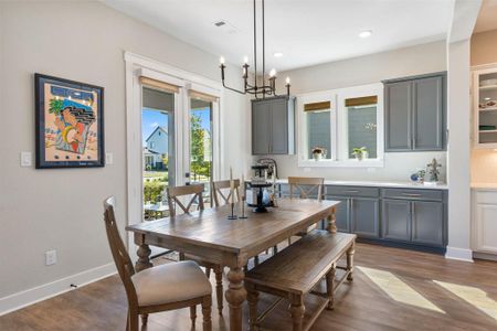 This central dining area features additional cabinets and counter space (use as a bar or buffet area). The tall glass French doors let in a lot of natural light and lead to a large front porch, perfect for enjoying morning coffee or evening cocktails.