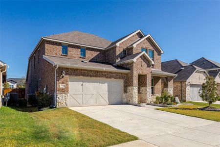 View of front of home with a garage and a front yard