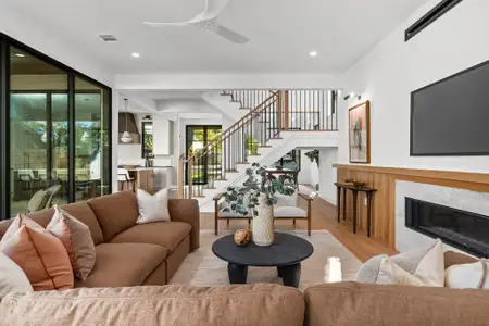 The living area is artfully divided from the kitchen and dining area by a floating staircase, allowing crucial free flow between the downstairs entertaining areas.