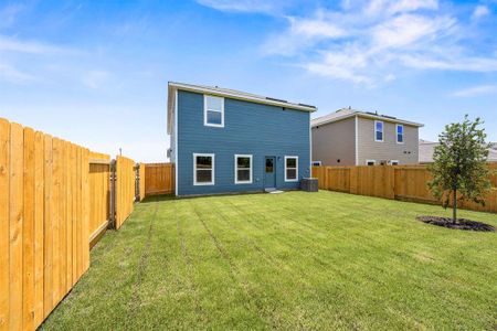 Rear view of property featuring a lawn and central air condition unit